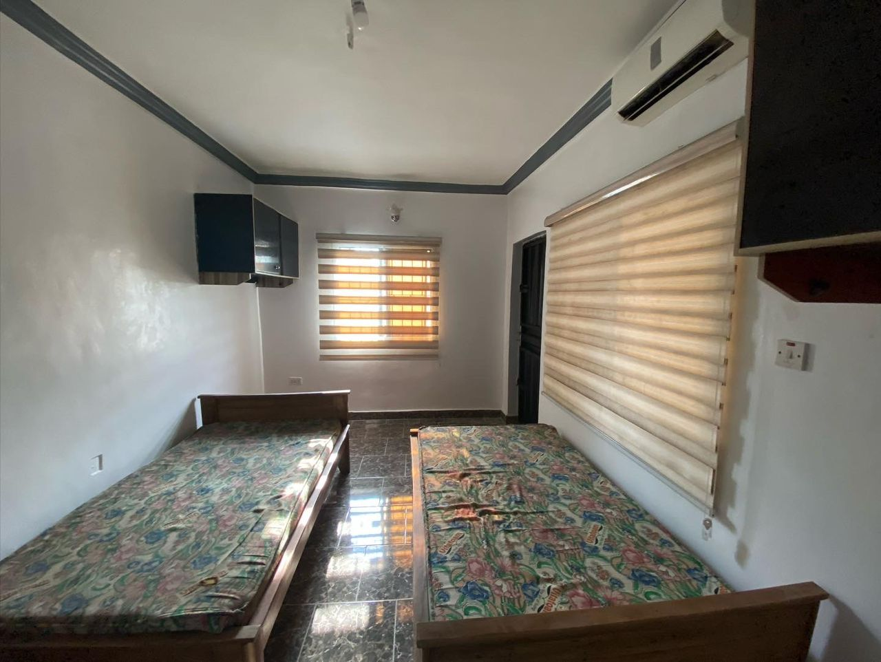 Bed space room with roller blinds and air conditioning at Rilwan AJALA Homes