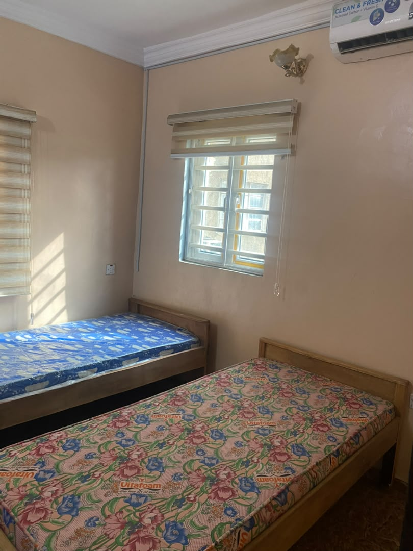 Bed space room at Rilwan AJALA Homes with two beds, AC and roller blinds