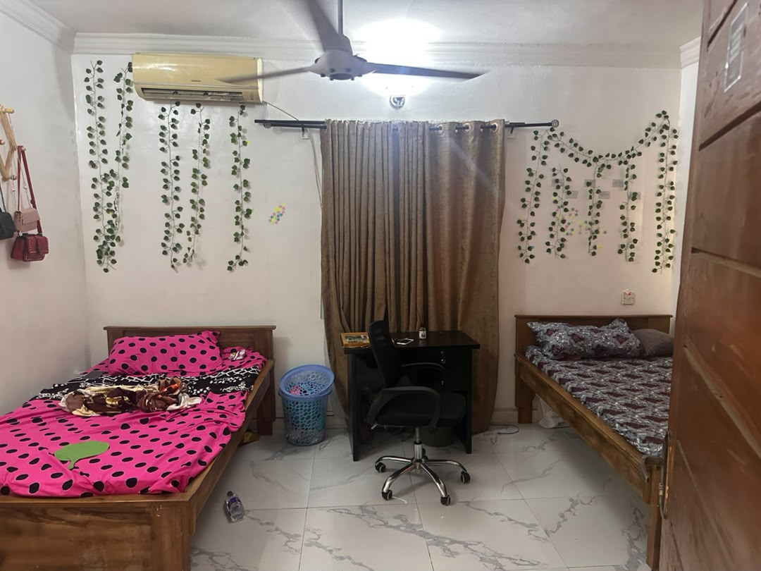 Bed space room at Rilwan AJALA Homes with AC, ceiling fan and decorative vine wall