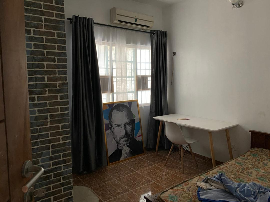 Room with brick feature wall and desk at Rilwan AJALA Homes Yaba