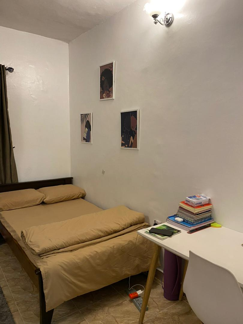 Single room with wall art prints and study desk at Rilwan AJALA Homes Yaba