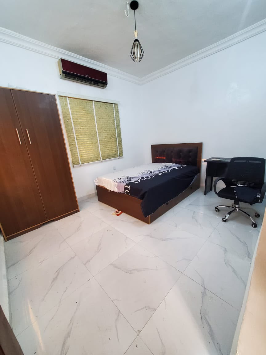 Single room at Rilwan AJALA Homes with marble floor, wardrobe, AC and pendant light